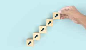 Business connecting piece of multi wood chart blocks steps in hand